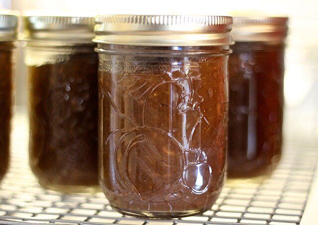 rich brow jujube butter in canning jars.
