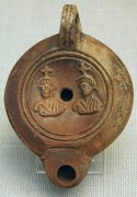 terra cotta oil lamp from ancient rome featuring castor and pollux