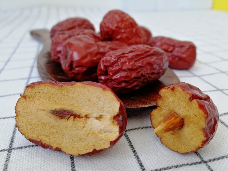 brown jujube fruit ant one cut open to show the pit