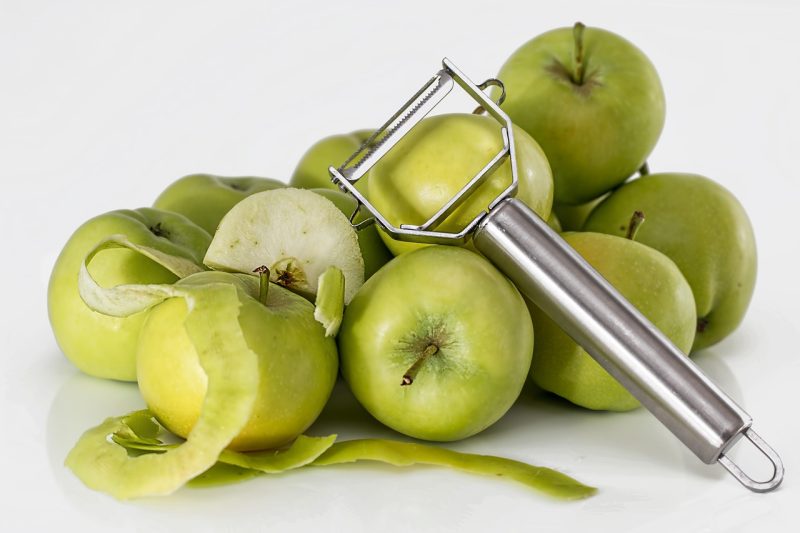 green granny smith apples and apple peeler