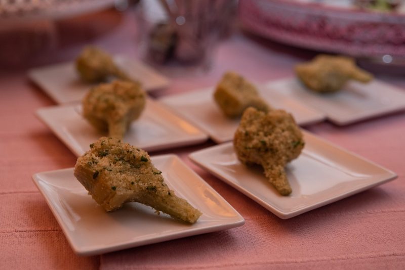 artichokes sliced stuffed cooked and served on individual plates