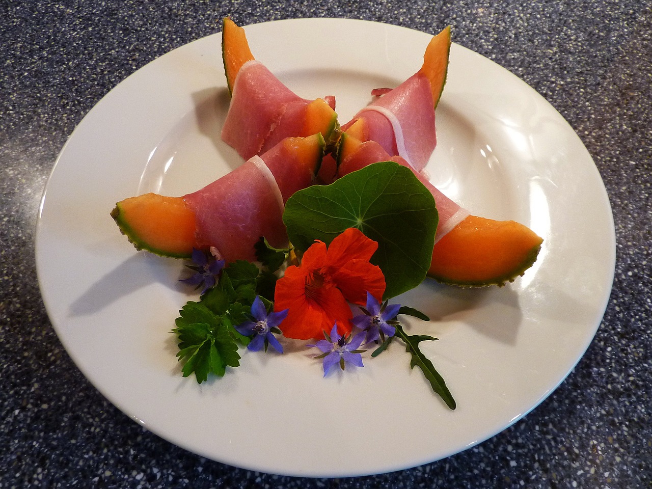 borage and nasturtium flowers with melon and ham