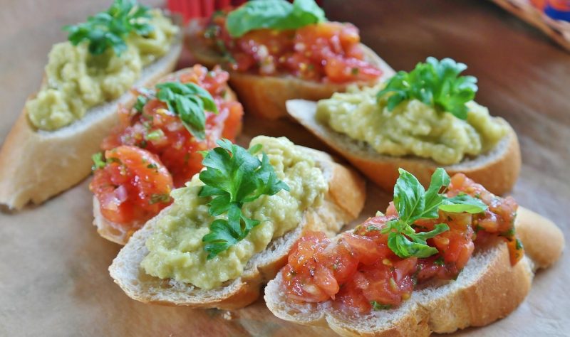 fresh green basil leaves topping bruschetta