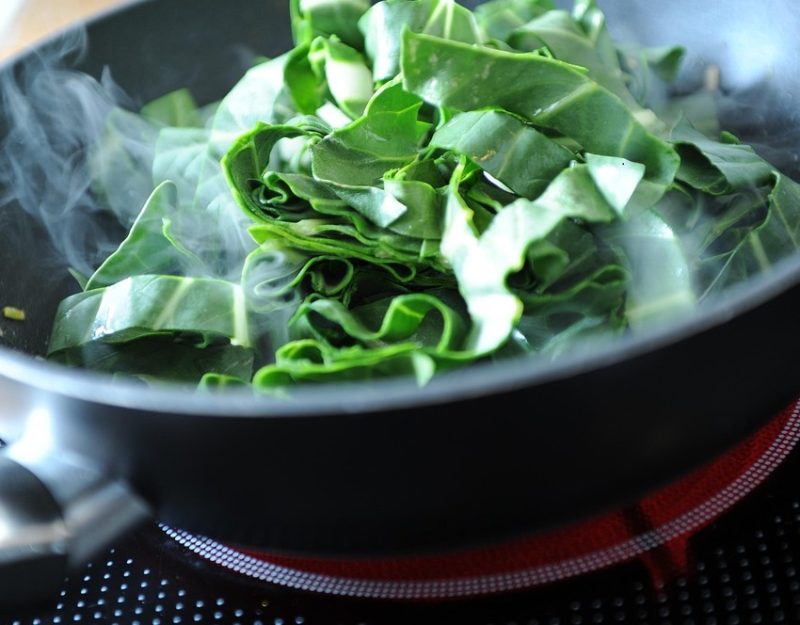 greens cooking in a pan