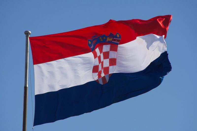 croatian flag. redon top, then white then blue with a coat of arms in the center
