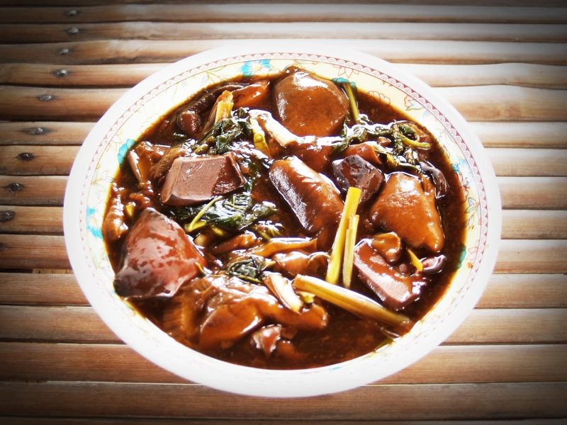 bowl of asian curry with stalks of lemongrass