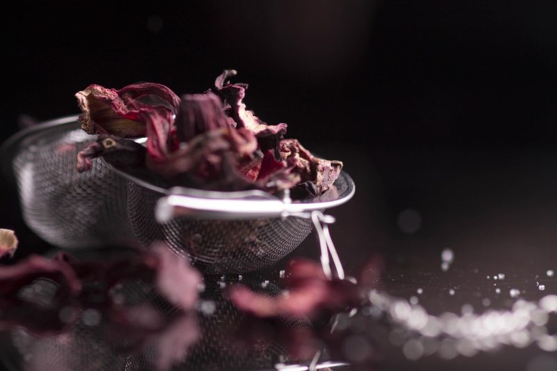 hibiscus flowers in a tea strainer