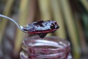 jar of jam with some on a spoon