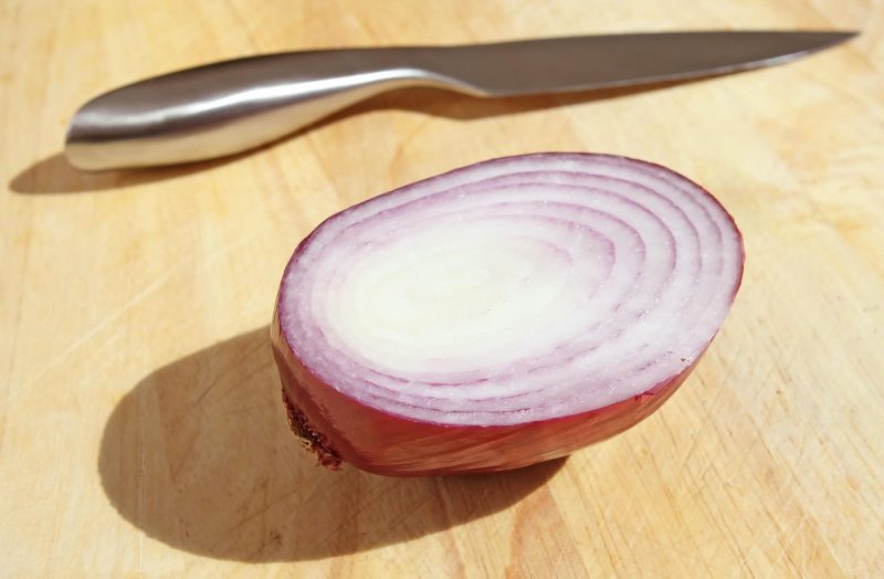 purple onion on cutting board