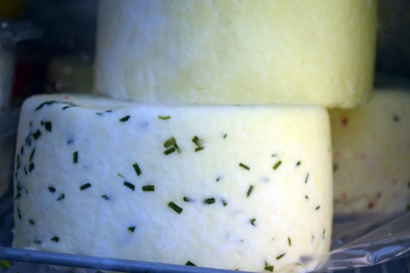soft white cheese with diced garlic chives in it