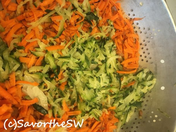 ground green zucchini and orange carrot in a collander copyright JASoule